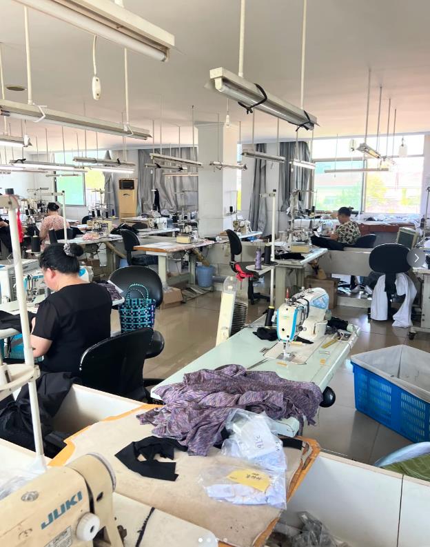 Garment sewing stations and workers at Bailing Apparel’s Dongguan workshop
